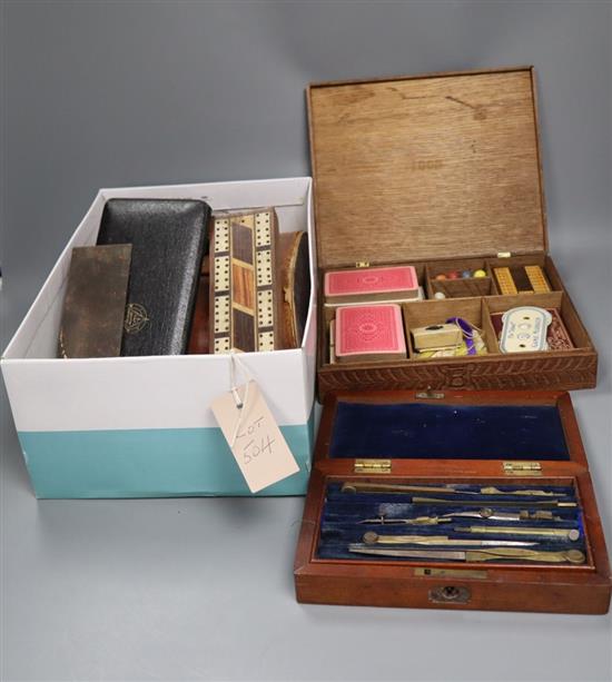 An oak cased games compendium, cased drawing instruments, binoculars, a Tunbridge ware cribbage board, etc.